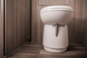 Close,up,of,white,toilet,in,tan,small,area,of